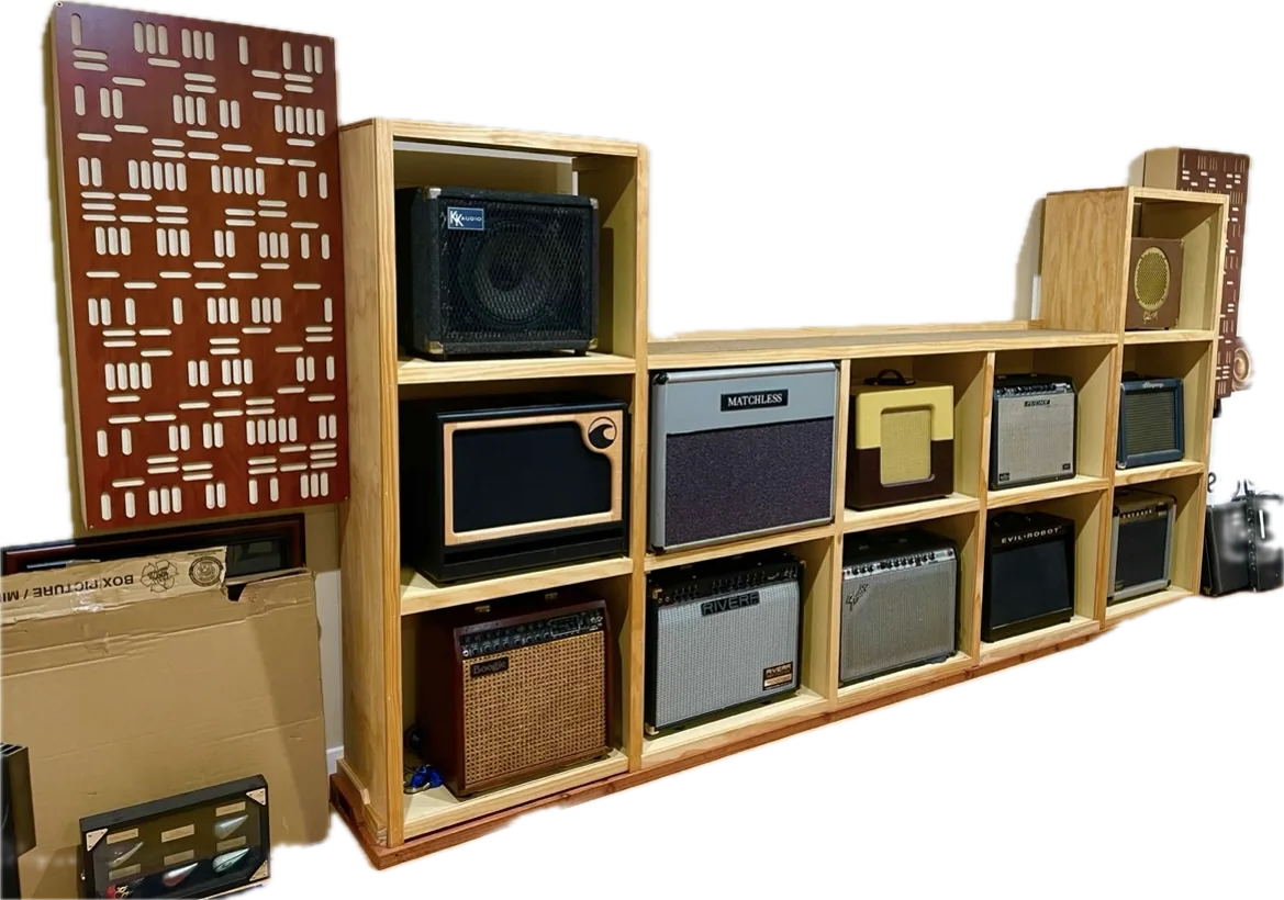 Built-in pine display shelving holding a collection of guitar amplifiers